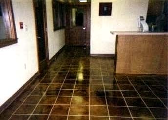 Image of tile pattern on indoor concrete floor.
